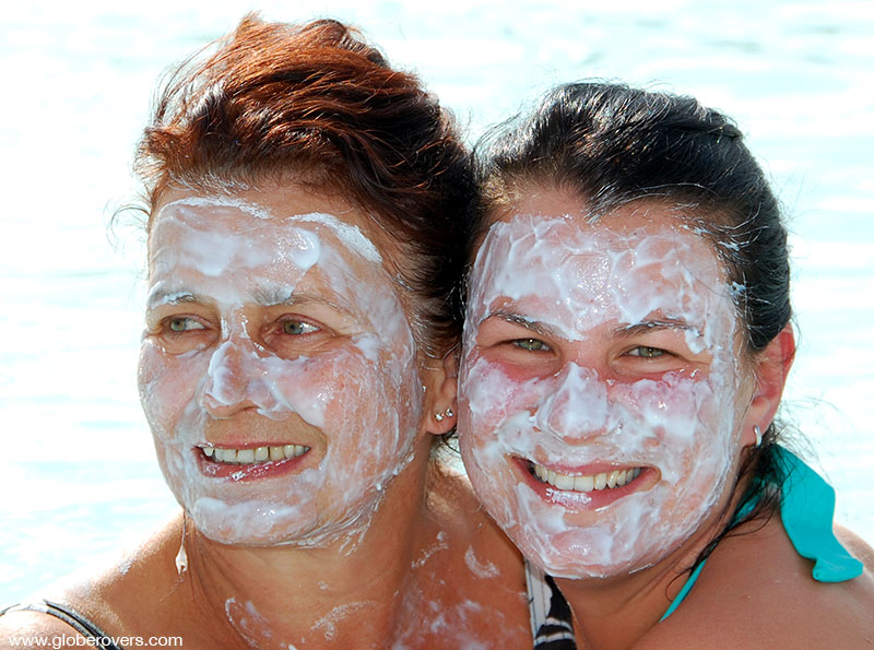 Get a white mud face pack while soaking in the hot springs at the Blue Lagoon, Iceland 