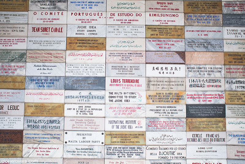 82 "friendship tribute" plaques from foreign supporters and Juche study groups against the wall of the interior entrance of the Juche Tower along the Taedong River, Pyongyang, North Korea, DPRK