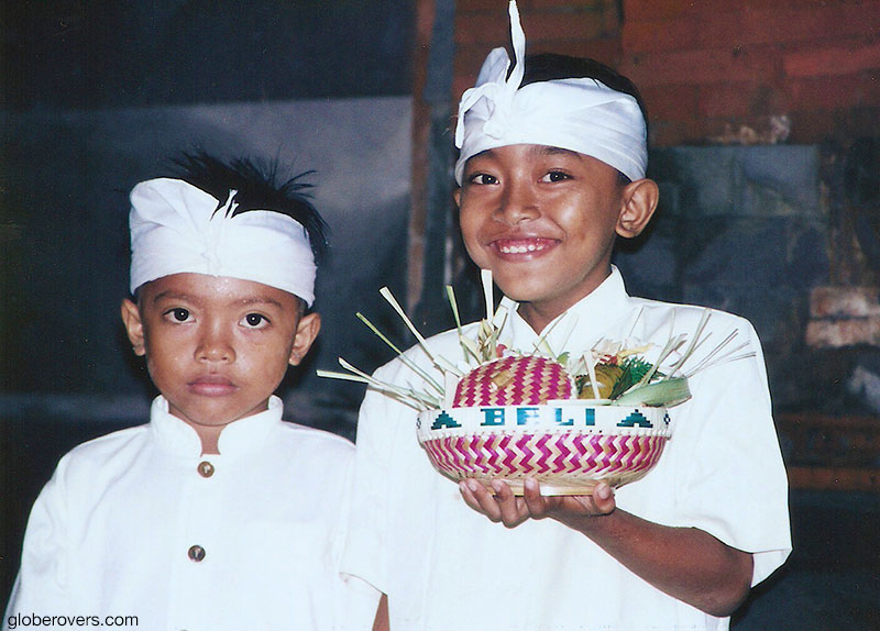 Balinese boys with their offerings, Bali, Indonesia