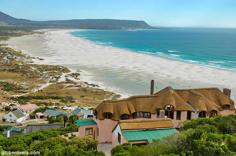 Noordhoek with Kommetjie at the far end. Note the lighthouse about halfway between the point and the mountain.