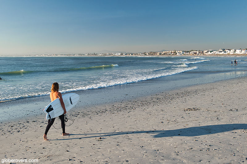 Surfer on the beach at Melkbosstrand, west coast, South Africa