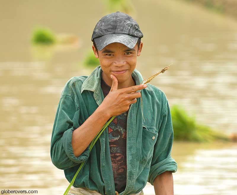 Boy working on the rice paddies near Vang Vieng, Laos