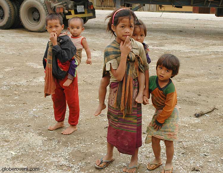 Kids by the side of the busy mountain road, Laos