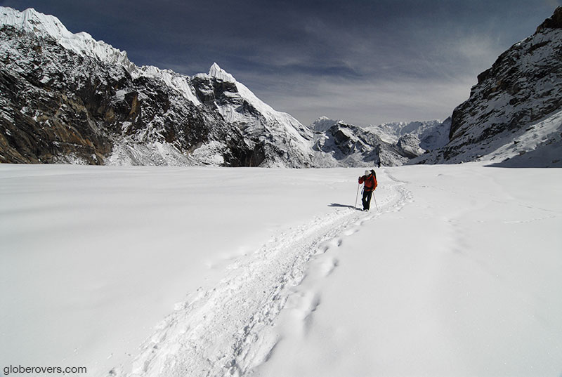 Hiking over a snow covered glacier near Cho La Pass, Himalayas, Nepal