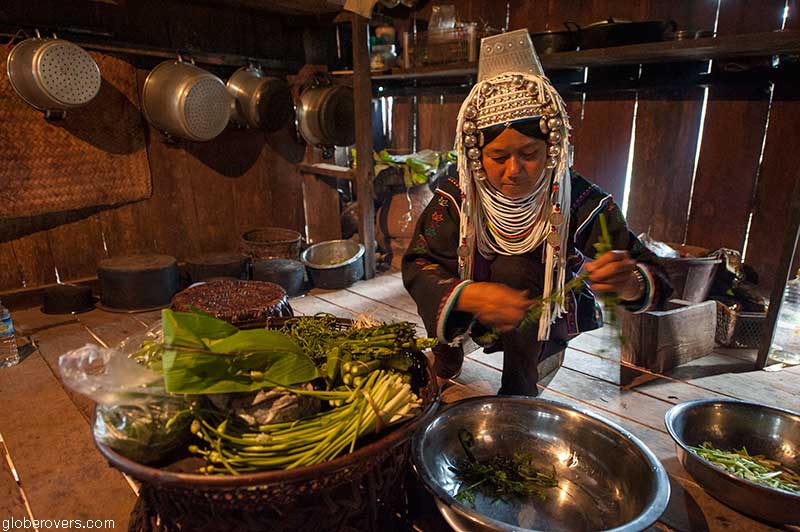 Woman preparing lunch at Ho Kyein Htet Akha village south of Kengtung, Shan State, Myanmar
