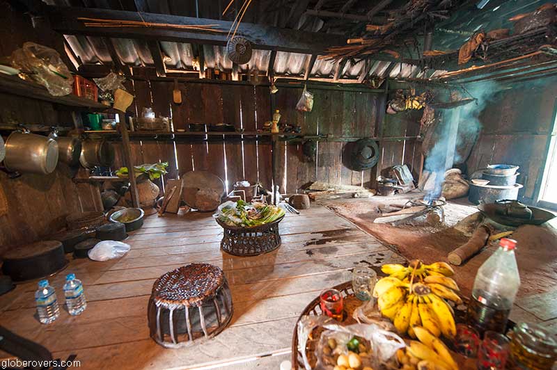 Woman preparing lunch at Ho Kyein Htet Akha village south of Kengtung, Shan State, Myanmar