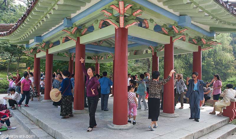 People dancing in a park, Pyongyang, North Korea, DPRK