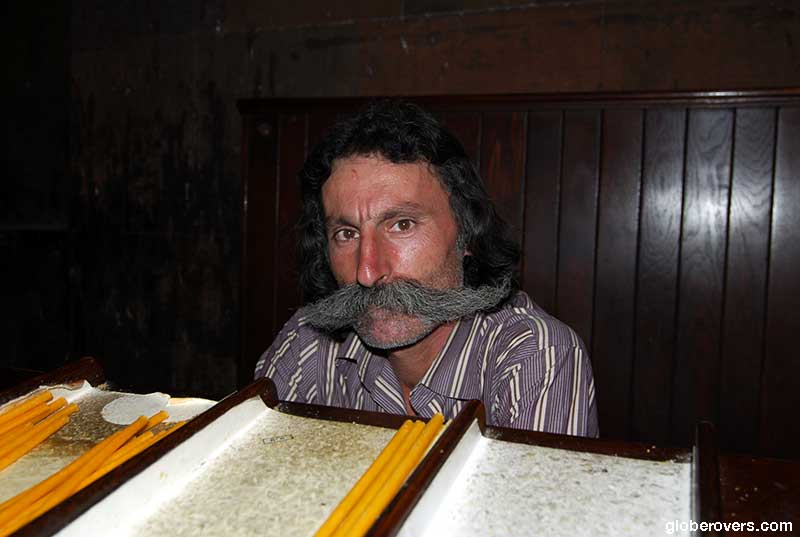 Moustached-man selling candles inside the Khor Virap Monastery, Armenia