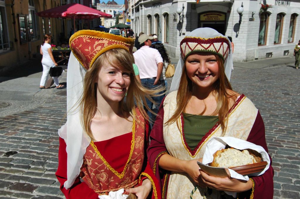 Girls selling chocolates on Town Hall Square (Raekoja Plats), Tallinn, Estonia